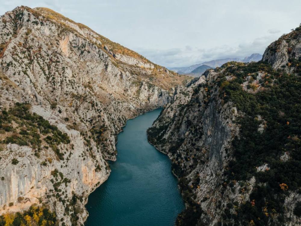 The turquoise water of Lake Komani running between steep cliffs in northern Albania