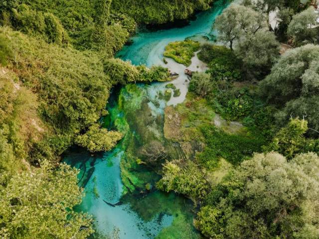 Aerial view of the Blue Eye spring and its turquoise river near Saranda