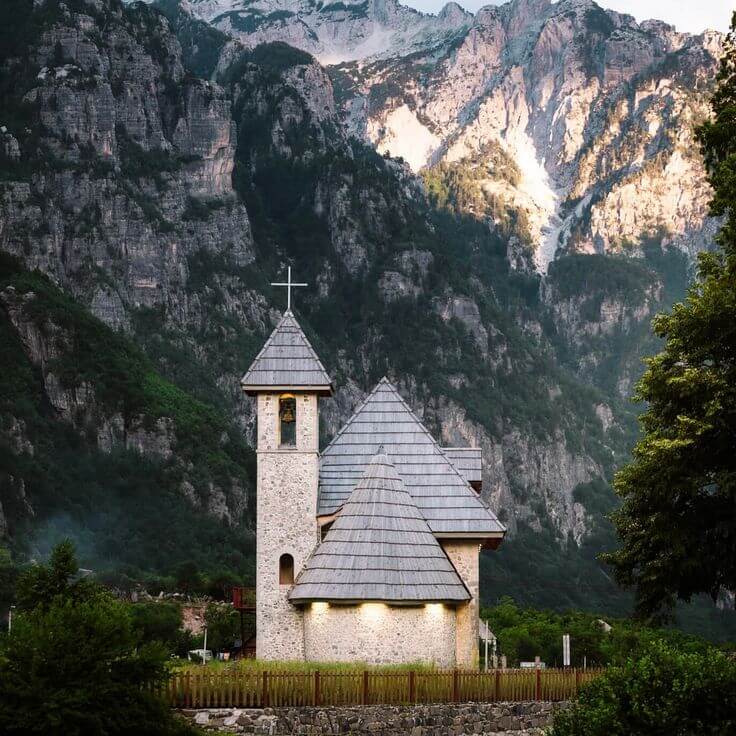 Stone church of Theth with the peaks of the Albanian Alps behind