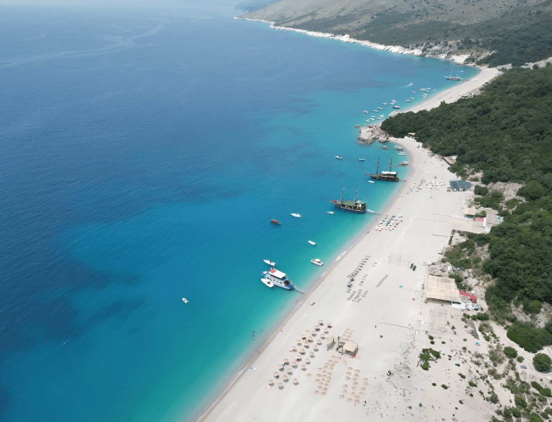 Kroreza beach with white pebbles and clear water near Saranda, seen from above