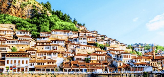 The white Ottoman houses of Berat, the city of a thousand windows, stacked above the Osum river