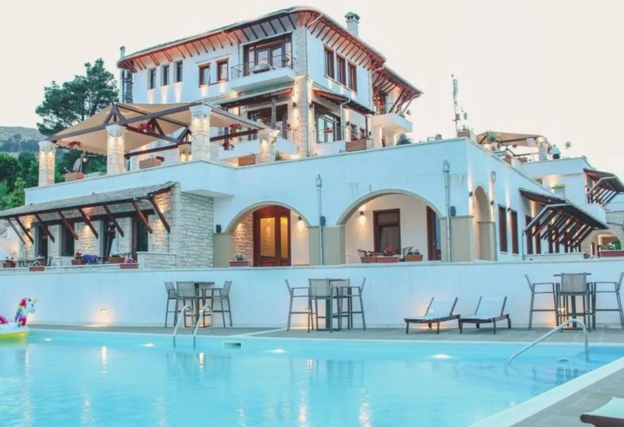 Boutique family hotel with swimming pool in the Albanian Riviera at dusk — the kind of hand-picked accommodation InAlb selects for family packages