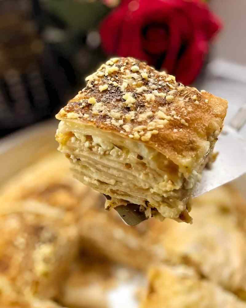 Close-up of a slice of Albanian byrek, a layered savoury pastry, in Tirana