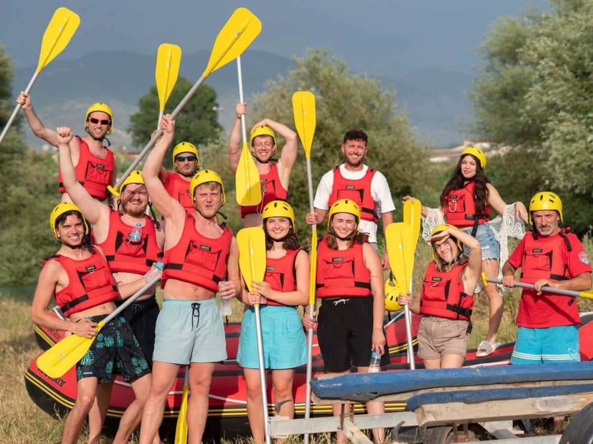 A rafting group posing with paddles beside the Bistrica River near Saranda