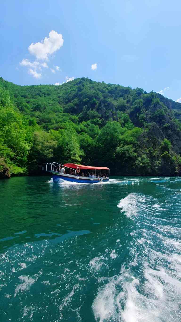 Boat on Koman Lake between steep cliffs in northern Albania