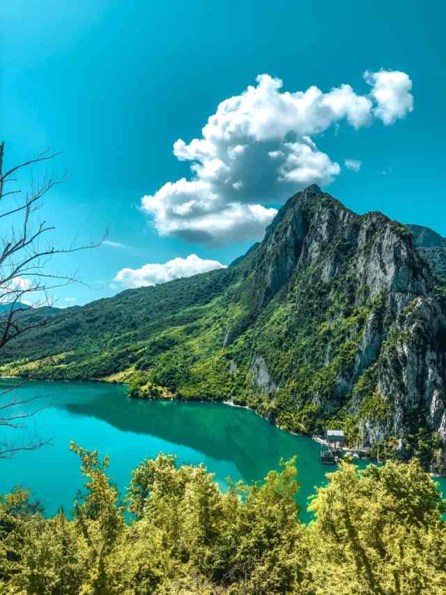 The turquoise water of Bovilla Lake below the rocky peak of Gamti Mountain near Tirana