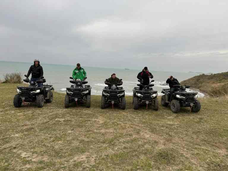 A line of parked quad bikes on the dunes near Cape of Rodon