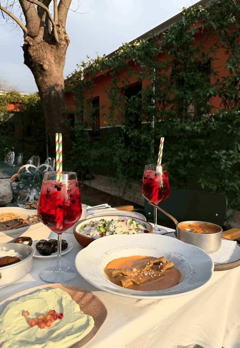 Outdoor table set with a farm-to-table lunch and drinks at an ex-military base near Tirana
