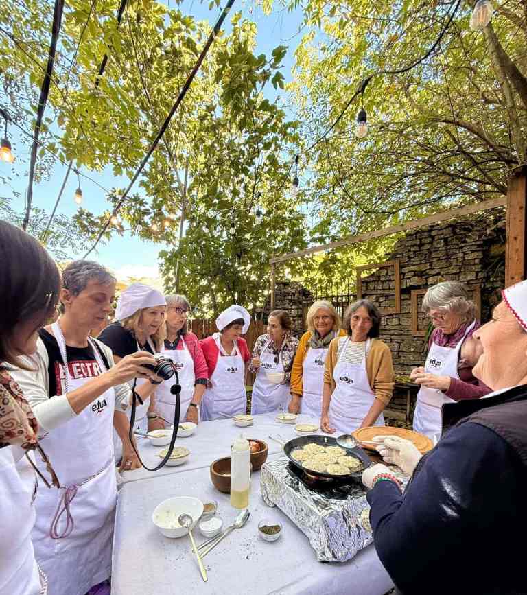 People cooking qifqi at an outdoor class in Gjirokastra's old bazaar