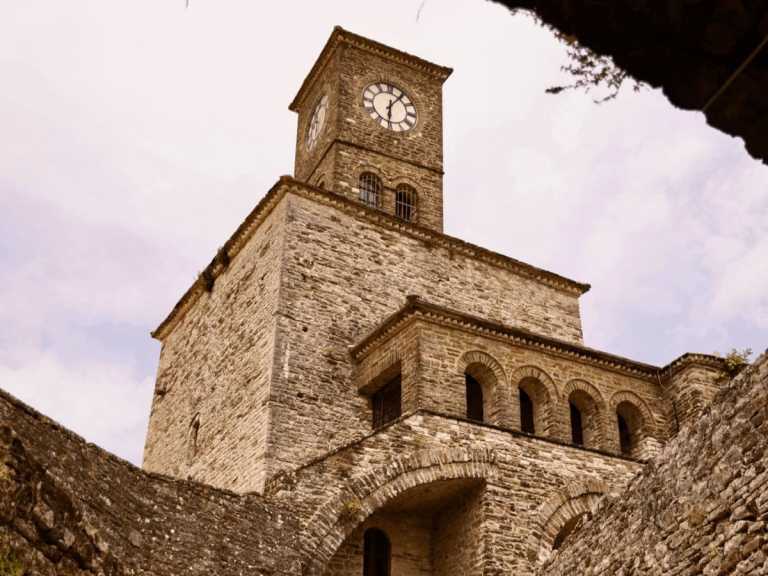 The old clock tower above the stone streets of Gjirokastra