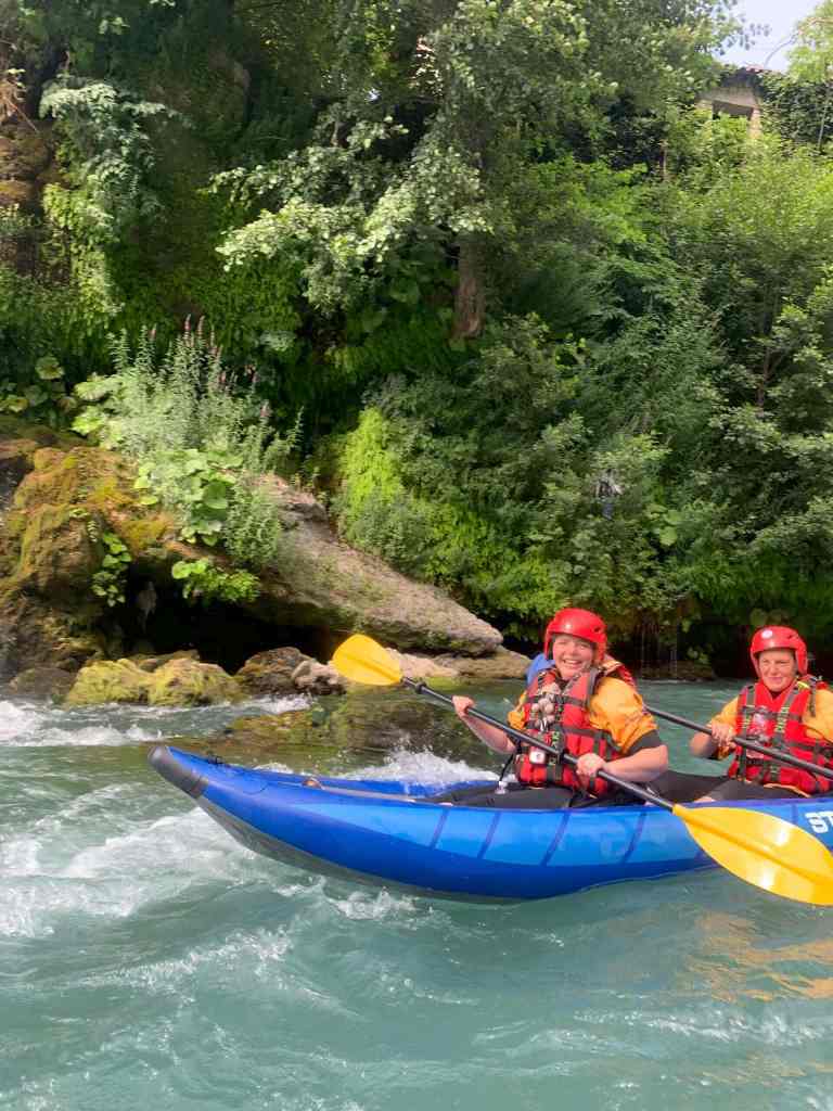 Two kayakers paddling the turquoise Vjosa river near Përmet