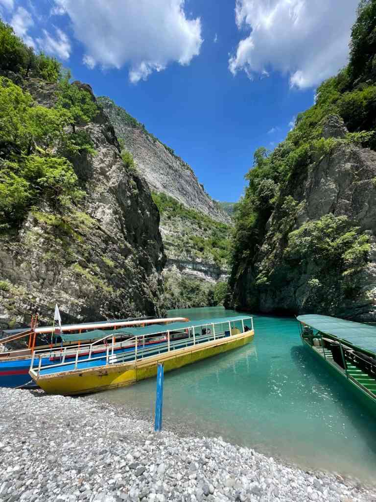 A passenger ferry boat docked in the gorge on Koman Lake on a Koman Lake and Shala River day trip from Tirana