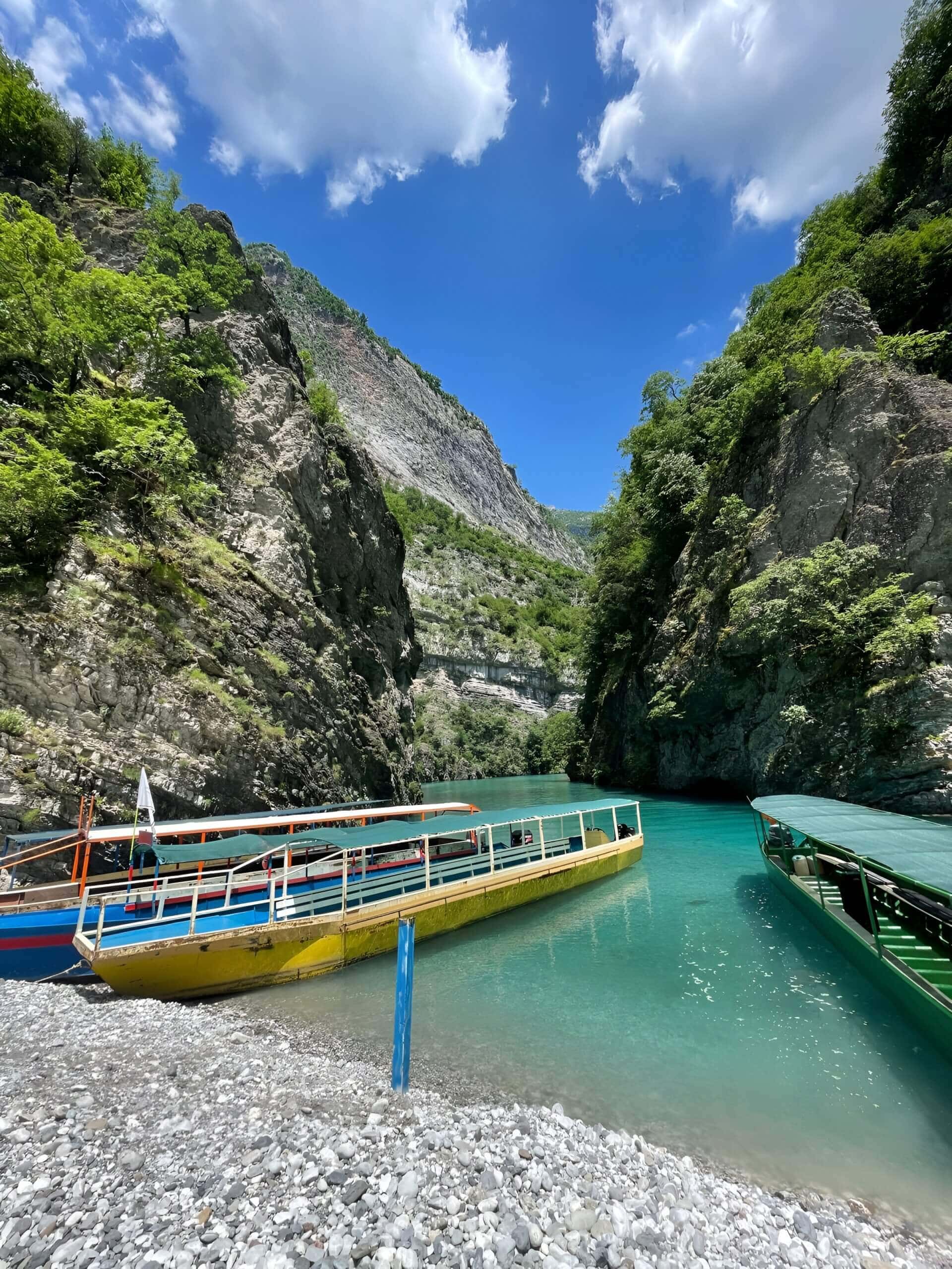 A passenger ferry boat docked in the gorge on Koman Lake on a Koman Lake and Shala River day trip from Tirana