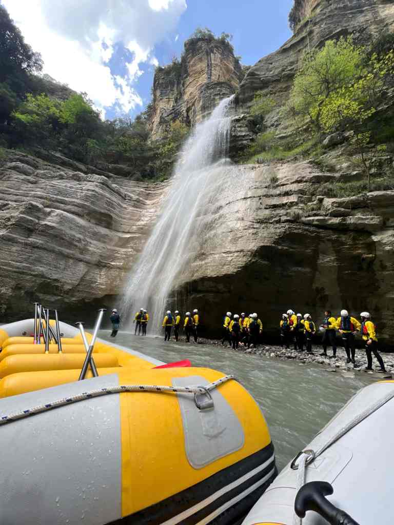 A yellow raft with paddlers on the green river in the Osum Canyon near Berat