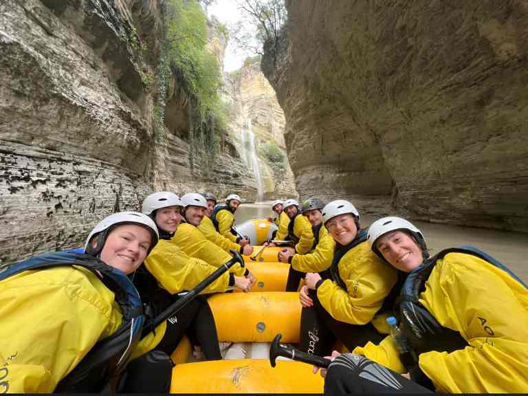 Friends taking a photo together while rafting in the Osum Canyon