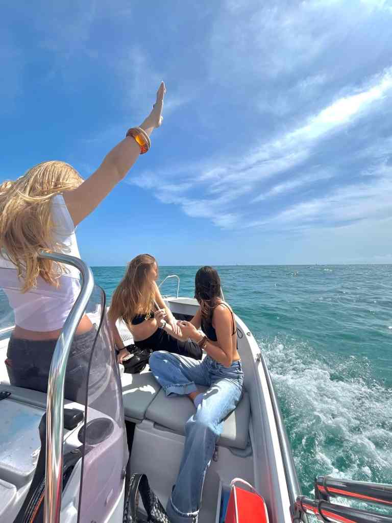Friends enjoying a speedboat ride under a blue sky on a Saranda boat tour along the Albanian Riviera