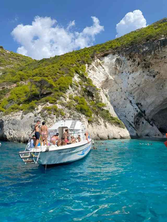 Boat trip under white cliffs into a turquoise cove near Saranda
