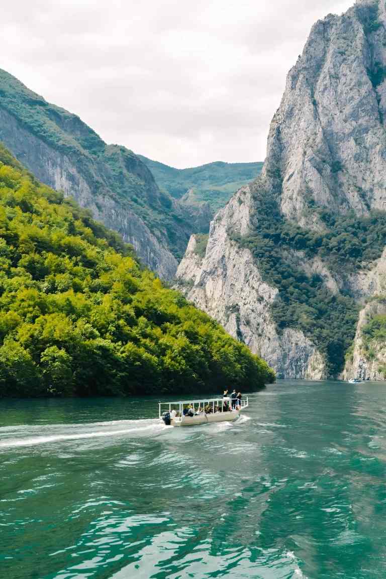 Boat on the Shala River between cliffs in the Albanian Alps