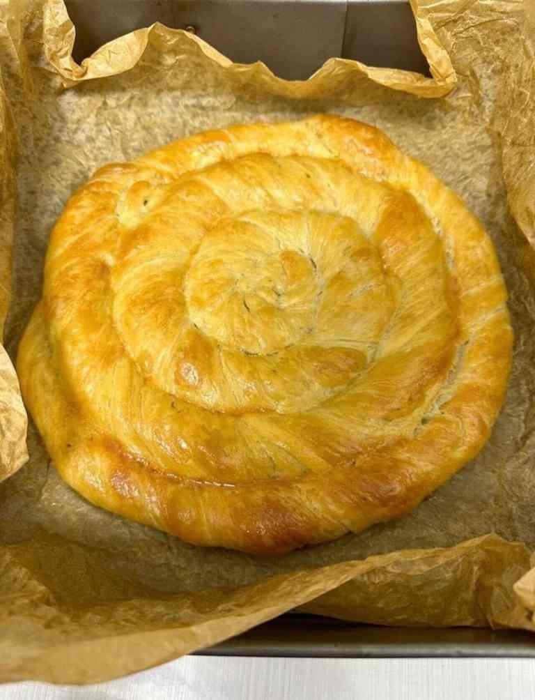 A golden spiral byrek pastry made in a Shkodra cooking class