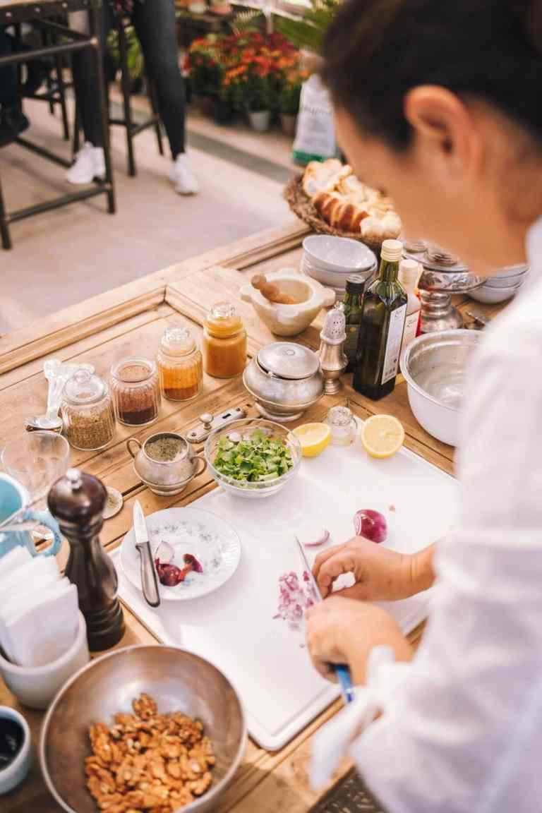 A host preparing fresh ingredients at a cooking class in Shkodra