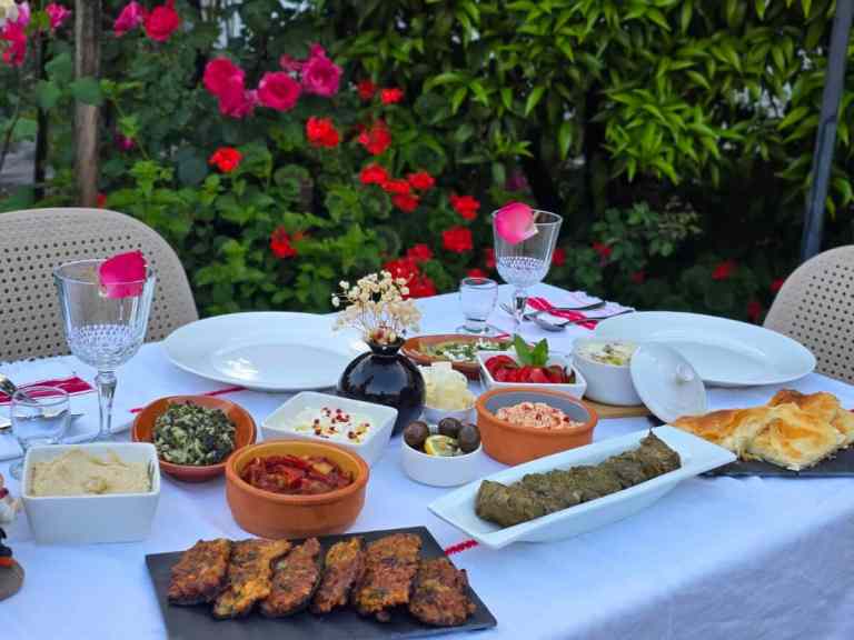 Outdoor table filled with traditional northern Albanian dishes during a food tasting in Shkodra