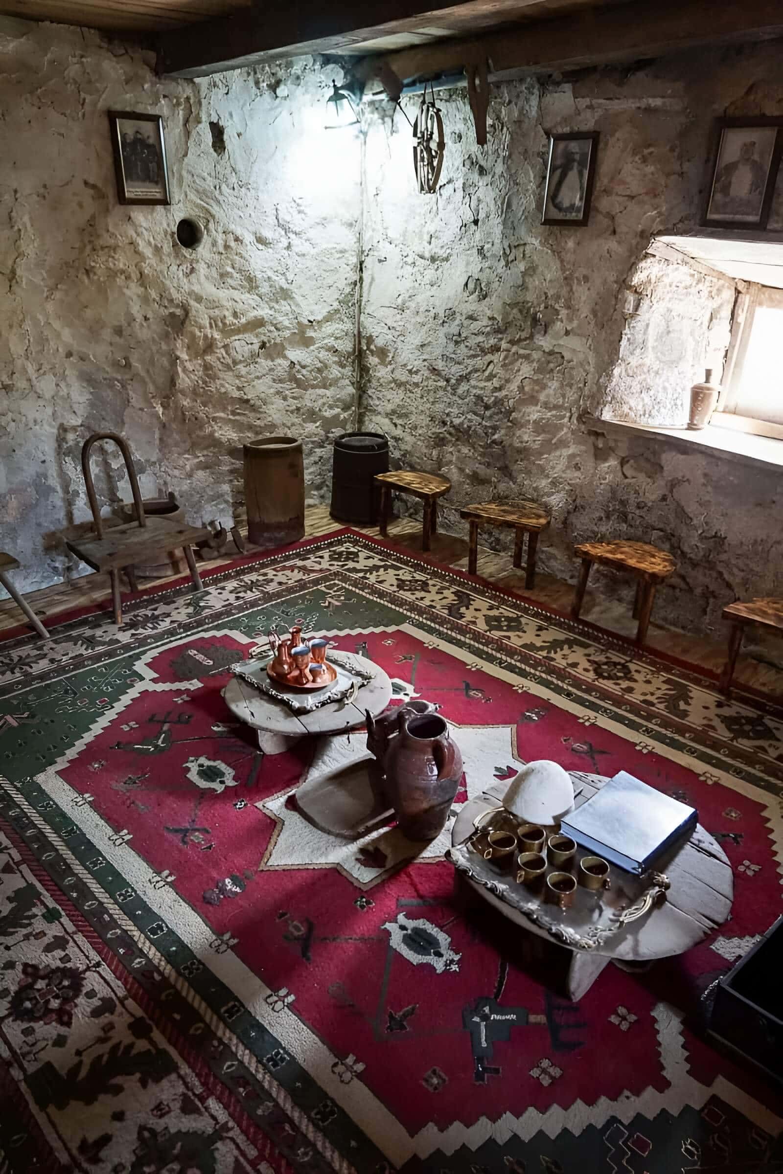 A traditional stone guesthouse table in Theth in the Albanian Alps, with a local meal and mountain light