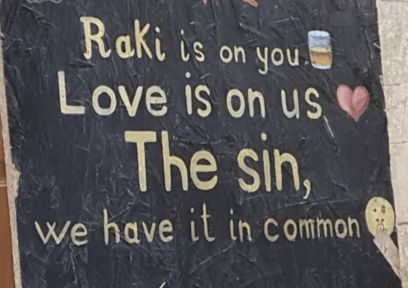 A chalkboard sign about raki at a tasting bar in Vlora