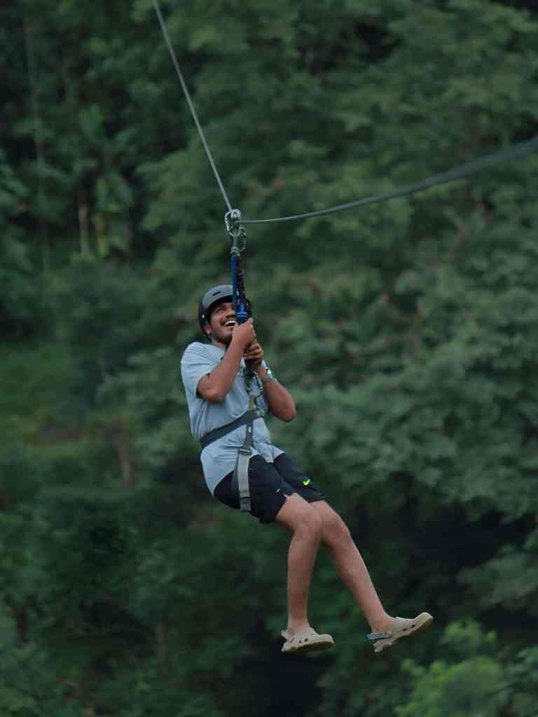 Man ziplining through the forest in Theth