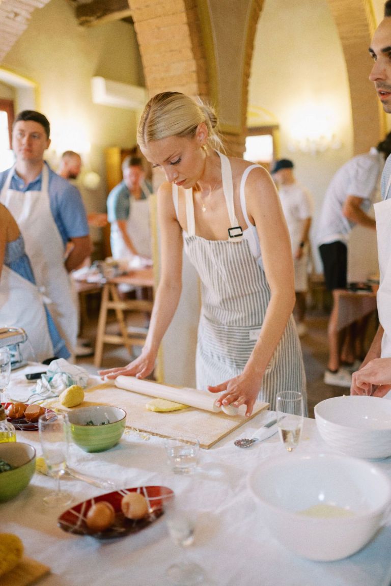 Travellers in aprons at a hands-on cooking class on the solo small-group tour of Albania
