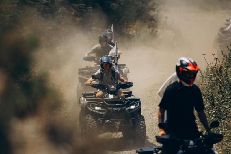ATV riders kicking up dust on a dirt trail during the Cape of Rodon quad bike ride near Durres, Albania