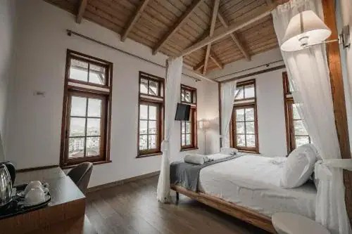 Traditional wood-beam room with canopy bed in a historic local-architecture house, Gjirokaster, Albania