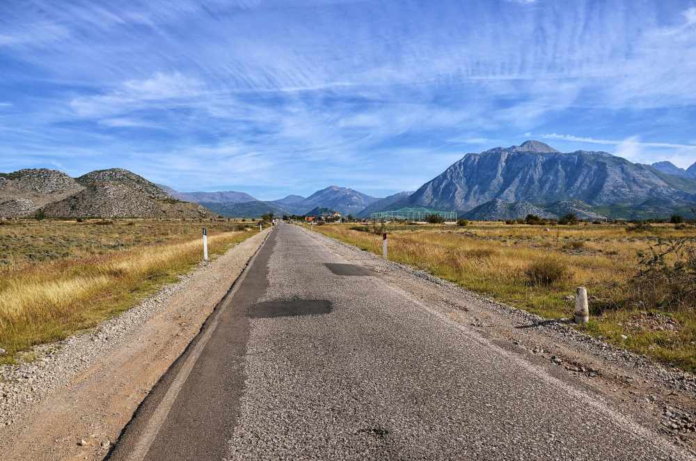 The SH21 road near Koplik, northern Albania: asphalted, a little worn, mountains ahead