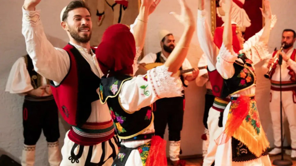Albanian folk dancers performing in traditional dress during a private culture tour